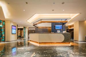 a lobby of a hotel with a reception desk at Yitel Xi'an Hi-tech Zone Wanda Plaza in Xi'an