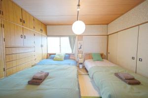 小樽市にある小樽運河まで徒歩7分 小樽のノスタルジックな戸建貸切 Tabiyadoのベッド2台が備わる客室です。