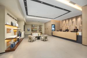 a lobby of a store with two people at a counter at Atour Hotel Dali Xiaguan Taiye International Plaza in Dali