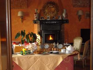 a living room filled with furniture and a fire place at Torre dei Frati Bed & Breakfast in Fossano
