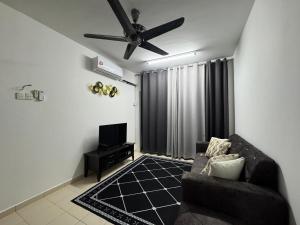 a living room with a couch and a ceiling fan at Homestay Tasik Biru Kundang in Rawang