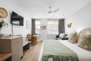 a bedroom with a bed and a living room at Bayscape Studio Glenelg in Glenelg