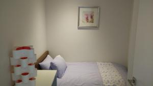 1 dormitorio con 1 cama y una foto en la pared en Camberwell Vacation Apartment, en Melbourne