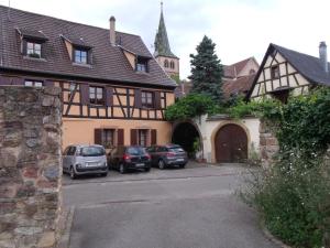 a group of cars parked in front of a building at Apt. La Grenouillère De Turckheim in Turckheim