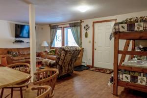 a living room with a bunk bed and a couch at Eagle's Eye Vacation Rentals in Sterling