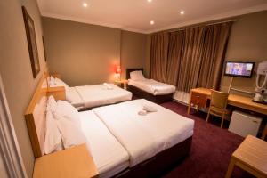 En eller flere senger på et rom på Newham Hotel