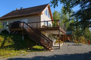 a house with a wooden staircase on the side of it at Eagle's Eye Vacation Rentals in Sterling