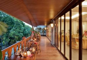 a balcony of a restaurant with tables and chairs at Sukajadi Hotel, Convention and Gallery in Bandung