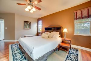 a bedroom with a bed and a ceiling fan at Ski Getaway with Hot Tub Reno Home by Attractions in Reno