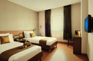 Tempat tidur dalam kamar di Sukajadi Hotel, Convention and Gallery