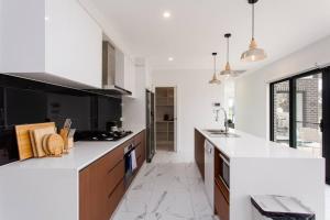 a kitchen with a white counter top and a sink at Bright and Chic House at Throsby with 4 Bedrooms in Harrison