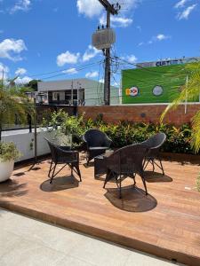 a group of chairs and tables on a wooden deck at Apartamento Amplo - Ideal para famílias in João Pessoa