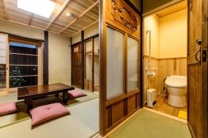 a small bathroom with a toilet and a table at Nadeshiko Shirakawa Machiya House in Kyoto +18 photos