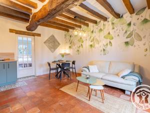 a living room with a couch and a table at Charmant gîte près d'Angers avec extérieur privé - FR-1-622-93 in Andard +14 photos