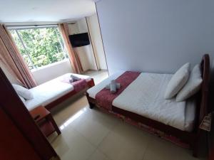 Postel nebo postele na pokoji v ubytování Hotel kristal campestre