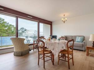 a living room with a table and chairs and a couch at Saint-Philibert: Appart 2 pièces, 53m², terrasse, parking, 4 pers - FR-1-477-249 in Saint-Philibert