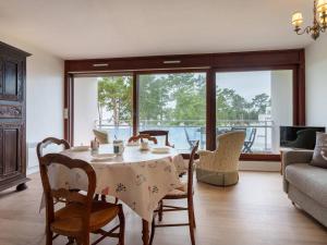 a living room with a table and chairs and a couch at Saint-Philibert: Appart 2 pièces, 53m², terrasse, parking, 4 pers - FR-1-477-249 in Saint-Philibert