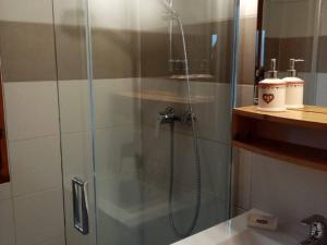 a shower with a glass door in a bathroom at Chalet spacieux 3 pièces avec parking et jardin - FR-1-593-122 in Les Angles
