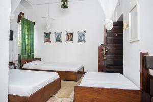 Postel nebo postele na pokoji v ubytování Malindi Guest House