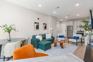 a living room with a couch and a table at King Bed - Stunning Pier Views - Near Fishtown in Philadelphia