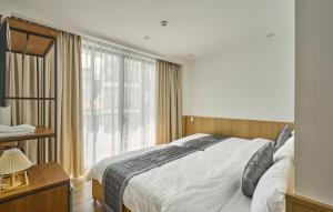 a bedroom with a bed and a large window at Ngọc Khánh Hotel in Da Lat
