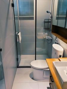 a bathroom with a toilet and a glass shower at Through A Path in Tainan