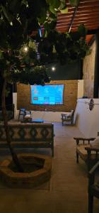 a stage with a tree and a large screen at Casa Nieto in Teotitlán del Camino