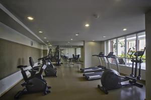a gym with a row of treadmills and elliptical machines at Cozy Living in Bangkok 60m to MRT near chatuchank in Bang Su