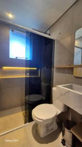 a bathroom with a white toilet and a sink at Refugio Bela Ilha Luxo Casal Acesso por Barco in Florianópolis