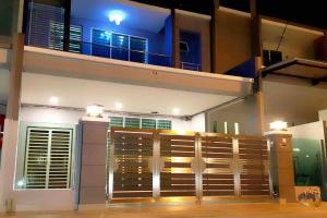 a view of a house at night with a balcony at OV 4 bedrooms, family 10-14 pax homestay in Ulu Melaka
