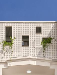 a white building with windows and plants on it at Ngọc Khánh Hotel in Da Lat +31 photos