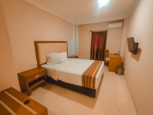 Ένα ή περισσότερα κρεβάτια σε δωμάτιο στο Sultan Hotel Banda Aceh