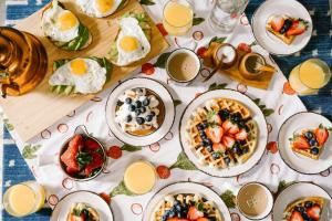a table topped with plates of food and drinks at Sailor Homes in Shertallai