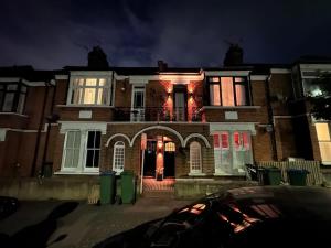 a large brick house with christmas lights on it at Modern Double bedroom in city apartment room 2 in London