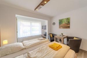 a bedroom with two beds and a desk and a table at Familienhof Brüning - Doppelzimmer Waldesruh II in Meppen