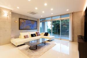 a living room with a couch and a table at Villa Sirene Ishigaki in Ishigaki Island