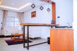 a living room with a table and a couch at Comfortable and Spacious house in Arusha