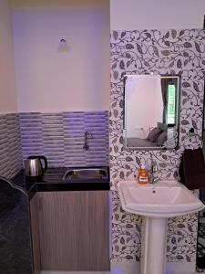 a bathroom with a sink and a mirror at Whispering Waves Luxury Homes in Majorda +28 photos