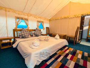 a bedroom with two beds in a tent at Dawat-e-Drung by FrozenFall Resort in Gulmarg