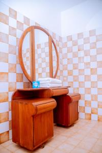 a wooden chair in a room with a mirror at Comfortable and Spacious house in Arusha +44 photos
