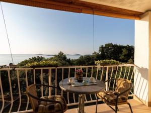 a table and chairs on a balcony with a view of the ocean at Apartments Belenum - Double Room with Balcony and Sea View no 2 in Mlini