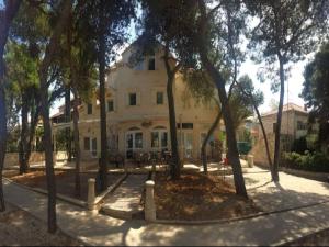 a large white building with trees in front of it at Apartment Simba - Studio Apartment ST in Supetar +8 photos