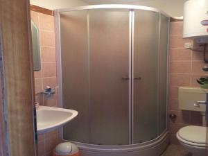 a shower in a bathroom with a sink and a toilet at Apartment Simba - Studio Apartment ST in Supetar
