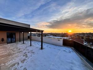 a view of the sunset from the roof of a building at Cozy Unique Penthouses with Terrace and Suceava Magic View in Suceava