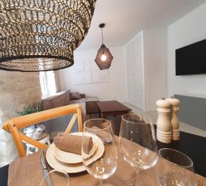 a dining room table with wine glasses and a chandelier at Hyper centre à 2 pas du port in Audierne +17 photos