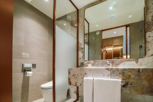 a bathroom with a sink and a mirror at The May Hotel in Jeonju