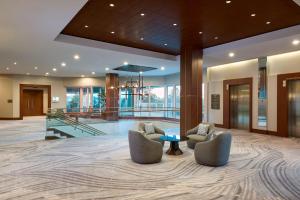 a lobby with two chairs and a table at The Westin Houston, Memorial City in Houston