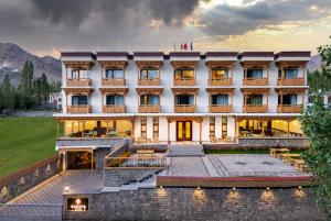 a hotel in the mountains with the sun setting at Hotel DE Suzain-Leh in Leh +15 photos