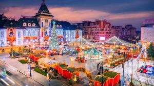 a christmas market in a city with christmas lights at Lucas Apartament in Craiova