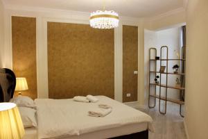 a bedroom with a bed with two towels on it at Book your Luxury Cozy Apartment in City Center Suceava in Suceava